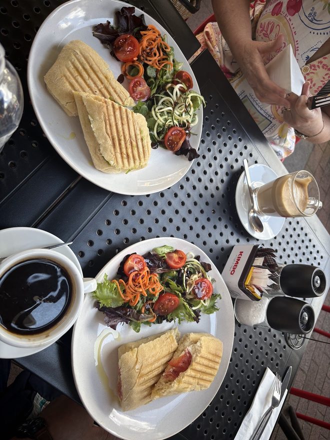 Two panini plates and coffees from above